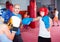 Boxing instructor closely follows the teenagers in sparring