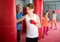 Boxing instructor and young children practicing blows