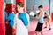 Boxing instructor and young children practicing blows