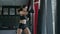 Boxing, woman fighter trains her punches, beats a punching bag, training day in the boxing gym, strength fit body, the