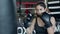 Boxing, woman fighter trains her punches, beats a punching bag, training day in the boxing gym, strength fit body, the