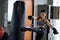 boxing woman kick huge punching bag in gym