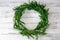 Boxwood wreath on white shiplap board background