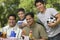 Boy (13-15) with father and brothers at picnic.