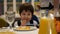 Boy 3-4 years to eat French fries and drink juice