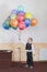 Boy 4 years holding colorful balloons. Happy boy on the stage holding balloons