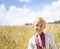 Boy 5 years old in national Ukrainian shirt against the background of a wheat field