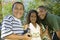 Boy (7-9) holding camcorder with younger sister (5-6) and older brother (10-12) portrait.