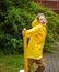 The boy of 8-9 years runs around a column in the yard.