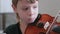 Boy of 8 years is learning to play violin.