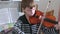 Boy of 8 years is learning to play violin.