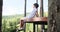 Boy admiring nature while relaxing on elevated wooden bench