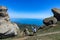 A boy against the background of ancient limestone high mountains. The Valley of Ghosts. Demerji. Crimea.