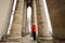 Boy against columns of baroque roman cattholic church in Pidhirtsi, Lviv Oblast, Ukraine