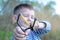 Boy Aiming Sling Shot at Camera