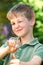 Boy Aiming Slingshot In Garden