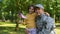 Boy with american flag hugging father military uniform, independence day, honor