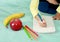 Boy with apple and book going back to school white background stock photo