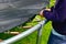 The boy assembles a new trampoline and stretches the springs to jump