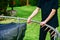 The boy assembles a new trampoline and tensions the springs