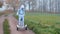 A boy in an astronaut costume rides a gyroscooter through the autumn forest.