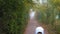 Boy in an astronaut costume stands on a gyroscooter in a foggy forest