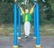 Boy athlete doing pull ups.Active lifestyle. The child performs exercises on uneven bars on the street.