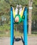 Boy athlete doing pull ups.Active lifestyle. The child performs exercises on uneven bars on the street.