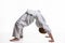 Boy athlete makes a bridge at the warm-up of the judo section