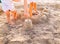 A boy and a baby, siblings, playing sandcastle building on the beach on a summer afternoon near their holiday hotel