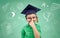 Boy in bachelor hat and eyeglasses over blackboard