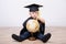 A boy in a bachelor or master suit with a globe on a light background. Early development, graduation, education, science, early