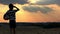 Boy with a ball in a field at sunset, boy dreams of becoming a soccer player