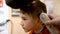 Boy in the barber shop. Close up of teenage boy being trimmed with professional electric clipper machine in barbershop