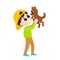 A boy in a baseball cap holds a small brown dog in his hands. Friendship between man and dog. The child is happy.