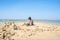 boy on the beach builds a sand castle on the seashore.