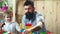 Boy and bearded man play together. Family and childhood concept. Father and son create colorful constructions with toy