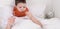 Boy in bed drinking medicine pill, washing down with water