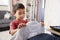 Boy In Bedroom Choosing Shirt Ready For School