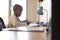 Boy In Bedroom Using Digital Tablet To Do Homework