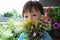 Boy behind the summer bouquet of wildflowers