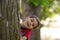 Boy behind tree