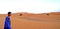 A boy berried in the dunes of the ERG desert in Morocco