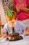 Boy on birthday party blowing a candles