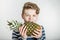 Boy Biting into Tough Skin of Pineapple