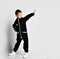 Boy in black warm jumpsuit with raised hand