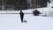 Boy in black winter clothes pulls a sledge to the top of the slope. Enjoying young age. Winter fun. Fooling around in the snow. Fu