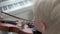 The boy is blond playing the violin, close-up