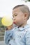 Boy blowing balloon