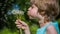 Boy blowing dandelion seeds